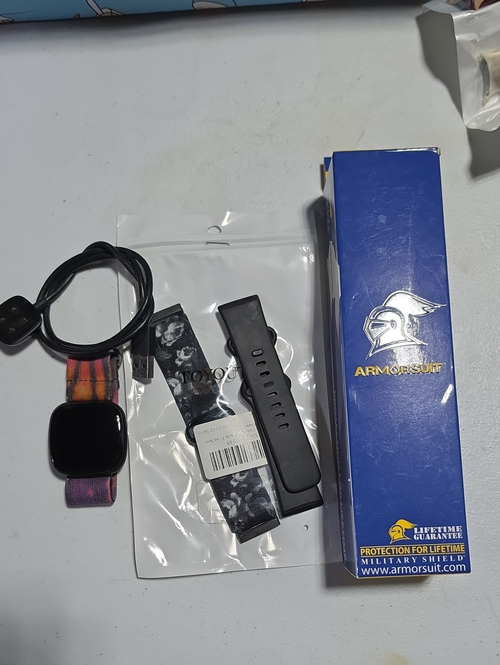 fitbit Versa 3 Smartwatch with black case and multicolor fabric band